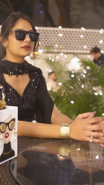 Black sequinned outfit with gold cuff